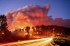 Seen in a long exposure photograph, the Park Fire burns along Highway 32 in the Forest Ranch community of Butte County, Calif., on Thursday, July 25, 2024. (AP Photo/Noah Berger)