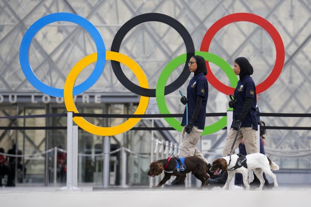 Members of the United Arab Emirates security team patrol a square near the Louvre in Paris, France, ahead of the opening ceremony of the 2024 Summer Olympics, Friday, July 26, 2024. (AP Photo/Ebrahim Noroozi)