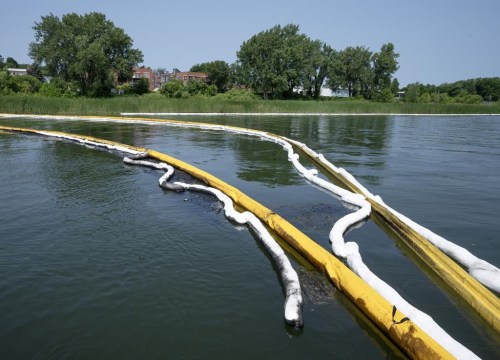 Buoys hold back oil Friday, July 26, 2024, in east end Montreal after the second unexplained spill in the past month. THE CANADIAN PRESS/Ryan Remiorz