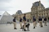 Members of the United Arab Emirates security team patrol a square near the Louvre in Paris, France, ahead of the opening ceremony of the 2024 Summer Olympics, Friday, July 26, 2024. (AP Photo/Ebrahim Noroozi)