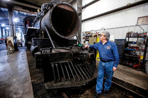 Paul Newsome, general manager of The Vintage Locomotive Society and the Prairie Dog Central Railway (PDCR) is photographed with the PDCR's steam locomotive engine in their rural workshop in Rosser, Man. just north of Winnipeg on Thursday, July 25, 2024.THE CANADIAN PRESS/John Woods