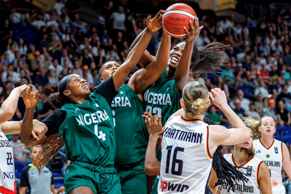 Germany's Alina Hartmann, right, tries to get the ball against, from right, Blessing Ejiofor, Lauren Ebo and Elizabeth Balogun from Nigeria during the Women International Basketball match between Germany and Nigeria at the Uber Arena in Berlin, Friday July 19, 2024. (Andreas Gora/dpa via AP)
