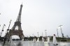 Saudi Arabia athletes walk across a bridge near the Eiffel Tower in Paris, France, during the opening ceremony of the 2024 Summer Olympics, Friday, July 26, 2024. (AP Photo/Andy Wong)