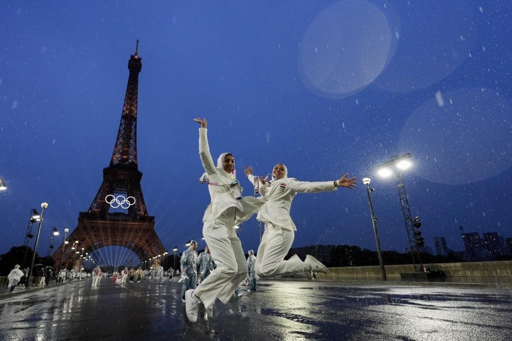 Egypt athletes leap while participating in the opening ceremony of the 2024 Summer Olympics, Friday, July 26, 2024, in Paris, France. (AP Photo/Andy Wong)