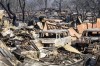 Vehicles scorched by the Park Fire line a yard in the Cohasset community of Butte County, Calif., on Friday, July 26, 2024. (AP Photo/Noah Berger)