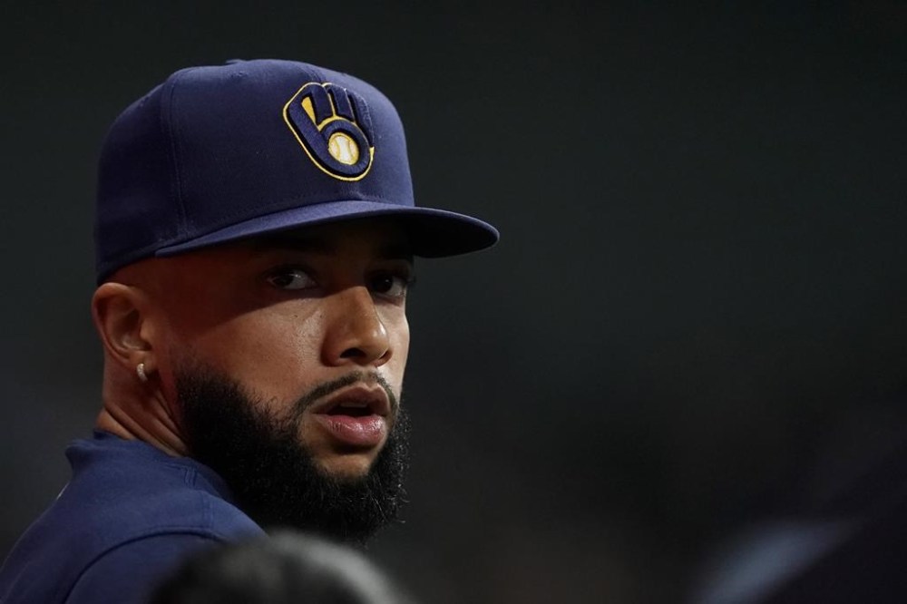 FILE - Milwaukee Brewers' Devin Williams watches from the dugout during the seventh inning of a baseball game against the Pittsburgh Pirates Wednesday, July 10, 2024, in Milwaukee. Williams appears on the verge of making his season debut after missing four months with stress fractures in his back. (AP Photo/Aaron Gash, File)