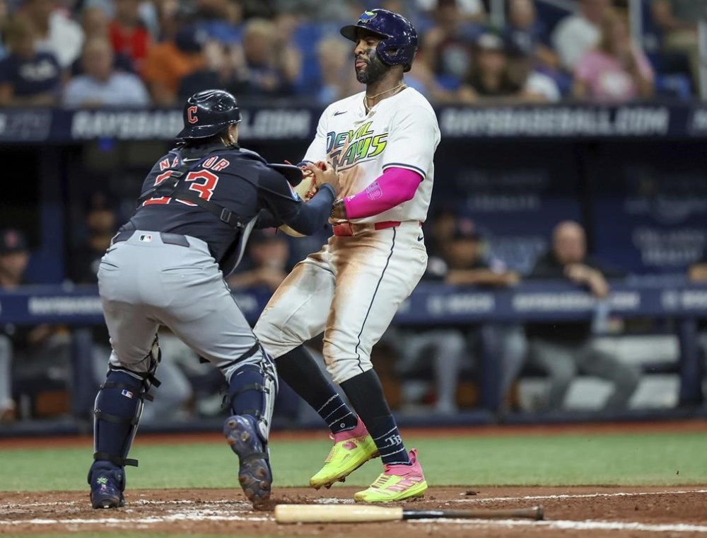 Cleveland Guardians catcher Bo Naylor, left, tags out Tampa Bay Rays' Yandy Diaz, right, during the fifth inning of a baseball game Friday, July 12, 2024, in St. Petersburg, Fla. (AP Photo/Mike Carlson)