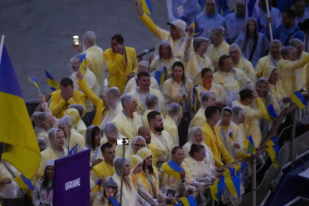 Team Ukraine travels along the Seine River in Paris, France, during the opening ceremony of the 2024 Summer Olympics, Friday, July 26, 2024. (AP Photo/Manu Fernandez)