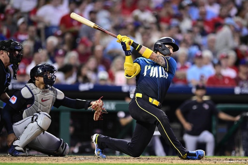 Philadelphia Phillies' Bryson Stott, right, watches his solo home run off Cleveland Guardians' Ben Lively during the fifth inning of a baseball game, Friday, July 26, 2024, in Philadelphia. (AP Photo/Derik Hamilton)