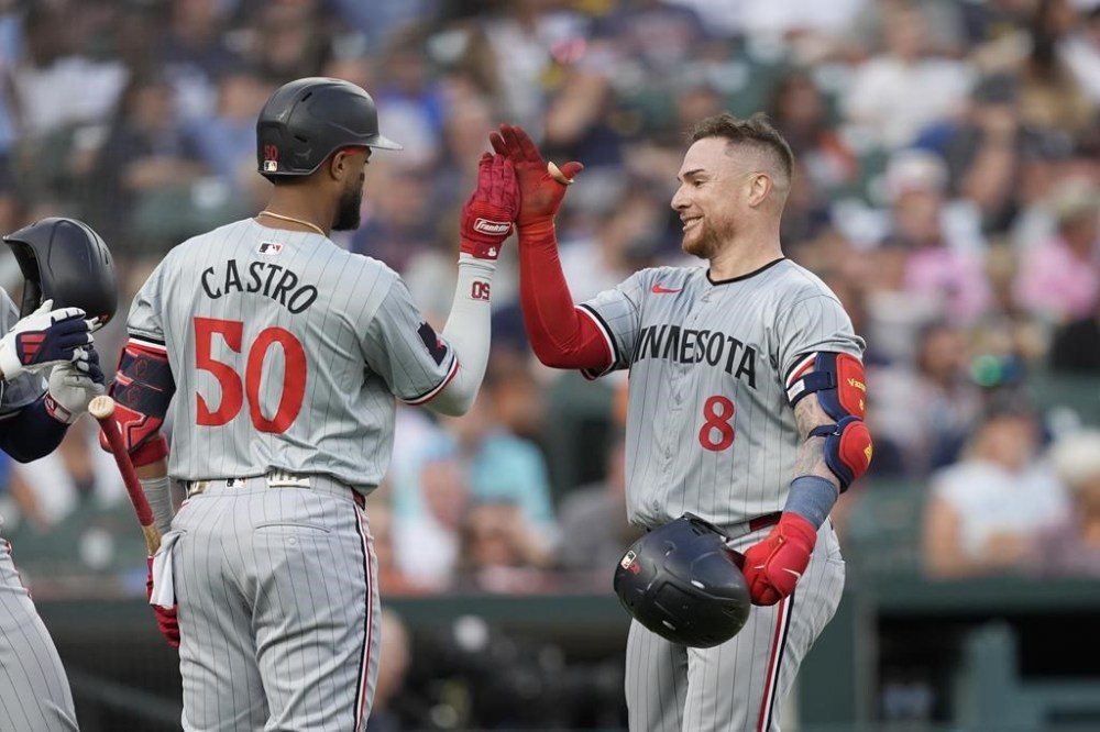 Minnesota Twins' Christian Vazquez (8) is greeted at home plate after a two-run home run during the sixth inning of a baseball game against the Detroit Tigers, Friday, July 26, 2024, in Detroit. (AP Photo/Carlos Osorio)
