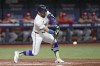 Tampa Bay Rays' Jose Caballero lines an RBI single off Cincinnati Reds starting pitcher Nick Lodolo during the second inning of a baseball game Friday, July 26, 2024, in St. Petersburg, Fla. (AP Photo/Christopher O'Meara)
