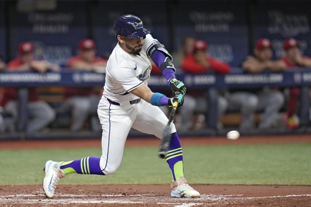 Tampa Bay Rays' Jose Caballero lines an RBI single off Cincinnati Reds starting pitcher Nick Lodolo during the second inning of a baseball game Friday, July 26, 2024, in St. Petersburg, Fla. (AP Photo/Christopher O'Meara)