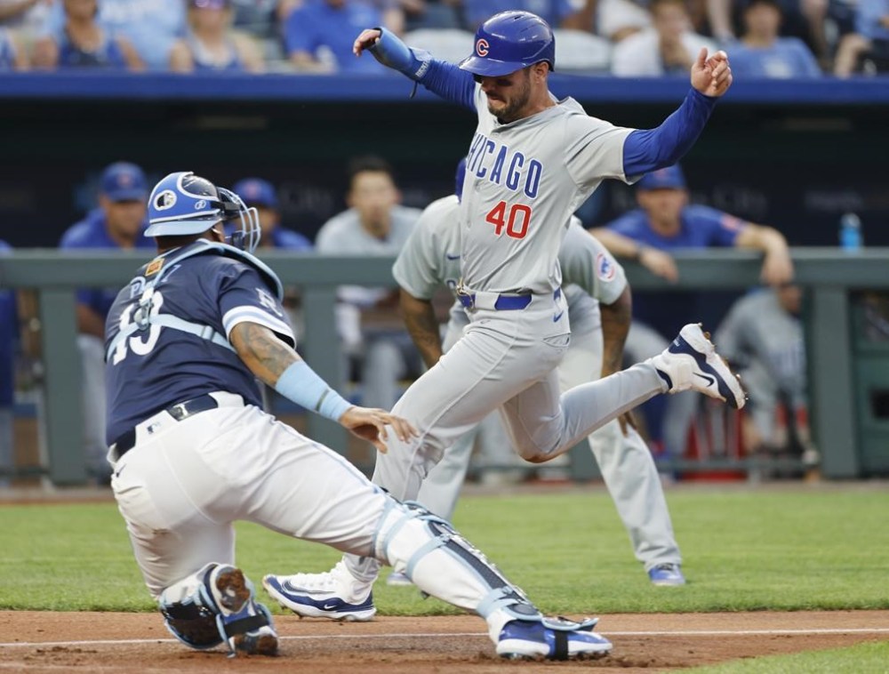 Chicago Cubs' Mike Tauchman (40) is tagged out at home plate by Kansas City Royals catcher Salvador Perez, left, after attempting to score from third off a flyout to right field by Miguel Amaya during the fifth inning of a baseball game in Kansas City, Mo., Friday, July 26, 2024. (AP Photo/Colin E. Braley)