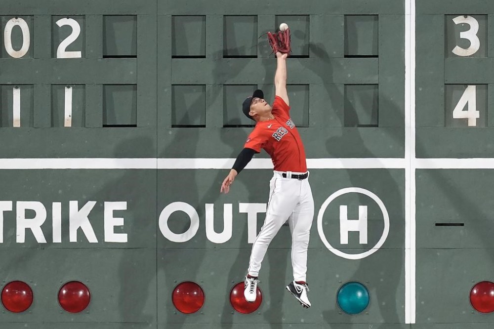 Boston Red Sox left fielder Rob Refsnyder can't make the catch on a double by New York Yankees' Gleyber Torres during the sixth inning of a baseball game Friday, July 26, 2024, in Boston. (AP Photo/Michael Dwyer)
