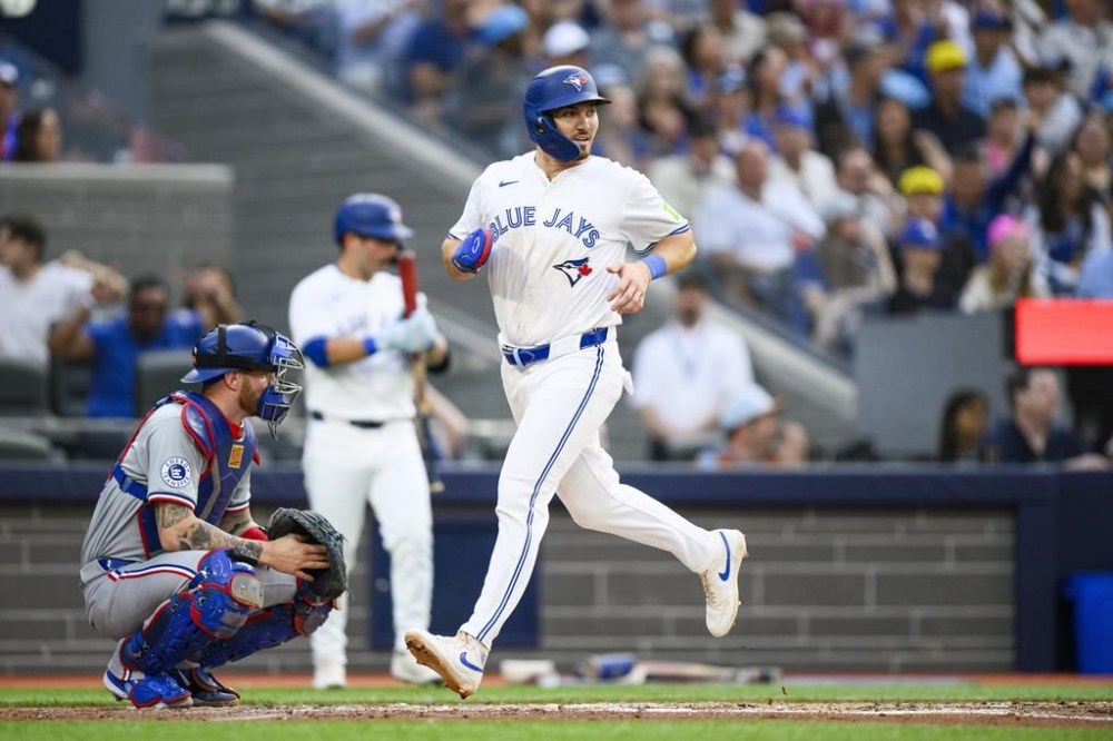 Toronto Blue Jays' Spencer Horwitz (48) scores a run during first inning MLB baseball action against the Texas Rangers, in Toronto, on Friday, July 26, 2024. THE CANADIAN PRESS/Christopher Katsarov