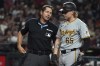 Pittsburgh Pirates' Jack Suwinski (65) talks to umpire Ben May, left, after striking out in the seventh inning during a baseball game against the Arizona Diamondbacks, Friday, July 26, 2024, in Phoenix. (AP Photo/Rick Scuteri)