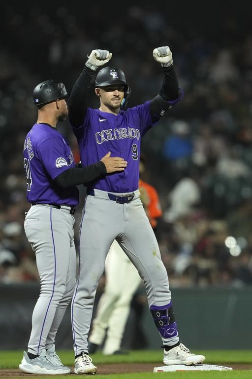 Colorado Rockies' Brenton Doyle, right, celebrates next to third base coach Warren Schaeffer after hitting a two-run triple against the San Francisco Giants during the eighth inning of a baseball game Friday, July 26, 2024, in San Francisco. (AP Photo/Godofredo A. Vásquez)