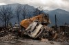 A small pile of burnt cars in Jasper, Alta., on Friday July 26, 2024. Wildfires encroaching into the townsite of Jasper forced an evacuation of the national park and have destroyed over 300 of the town's approximately 1100 structures, mainly impacting residential areas. THE CANADIAN PRESS/Amber Bracken
