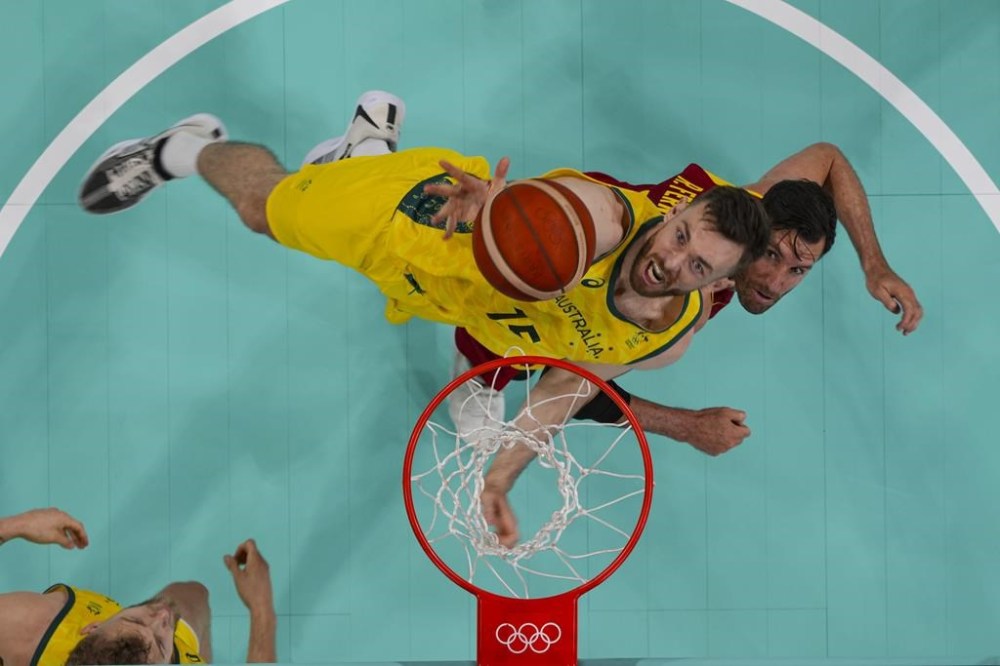 Nick Kay, of Australia, shoots over Rudy Fernández, of Spain, during a men's basketball game at the 2024 Summer Olympics, Saturday, July 27, 2024, in Lille, France. (Brian Snyder/Pool Photo via AP)