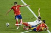 England's John Stones, center, Spain's Rodri, bottom, and Robin Le Normand fight for the ball during the final match at the Euro 2024 soccer tournament in Berlin, Germany, Sunday, July 14, 2024. (AP Photo/Thanassis Stavrakis)