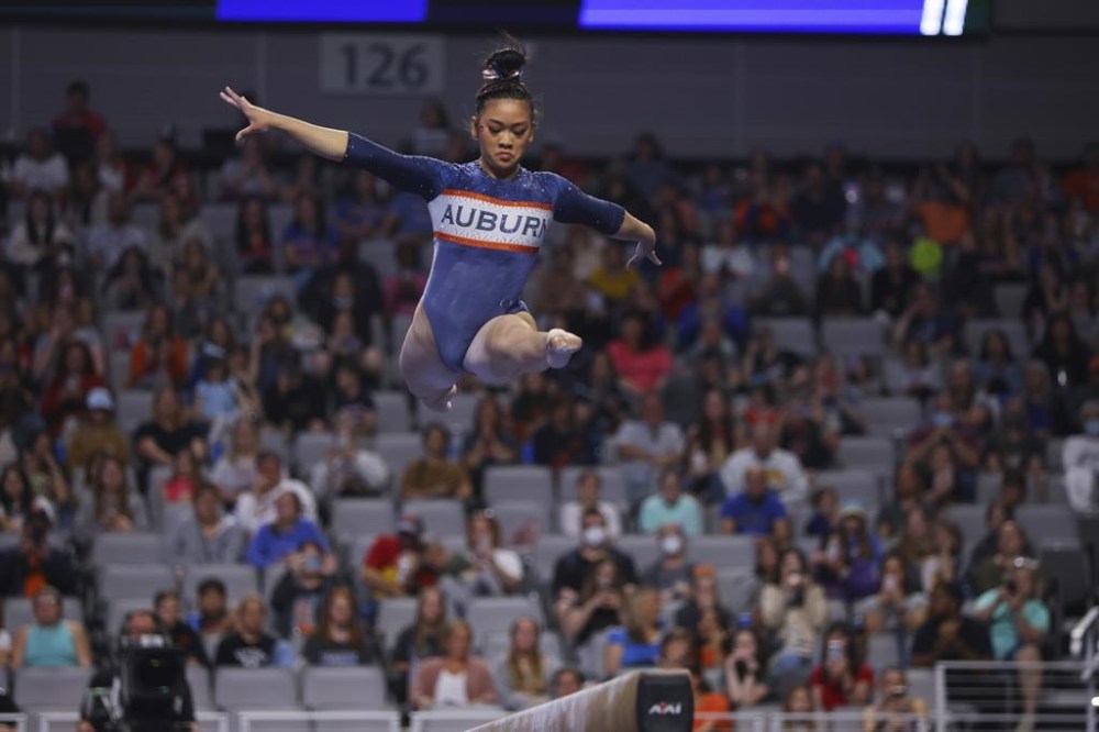 FILE - Auburn's Sunisa Lee competes on the balance beam during the NCAA college women's gymnastics championships, April 16, 2022, in Fort Worth, Texas. (AP Photo/Gareth Patterson, File)