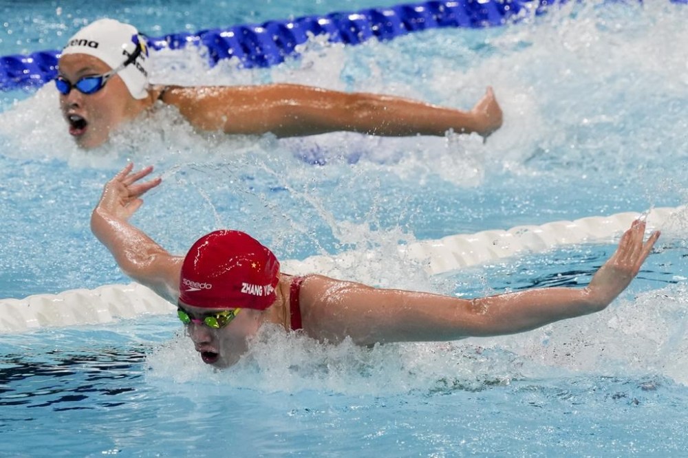 Zhang Yufei, of China, competes during a heat in the women's 100-meter butterfly at the 2024 Summer Olympics, Saturday, July 27, 2024, in Nanterre, France. (AP Photo/Martin Meissner)