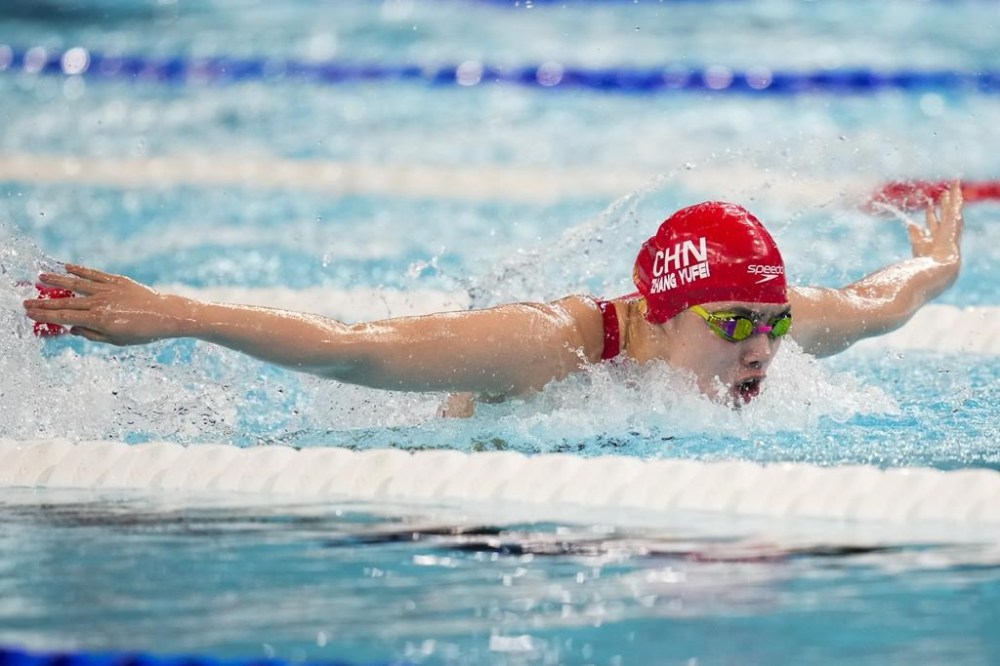 Zhang Yufei, of China, competes during a heat in the women's 100-meter butterfly at the 2024 Summer Olympics, Saturday, July 27, 2024, in Nanterre, France. (AP Photo/Ashley Landis)
