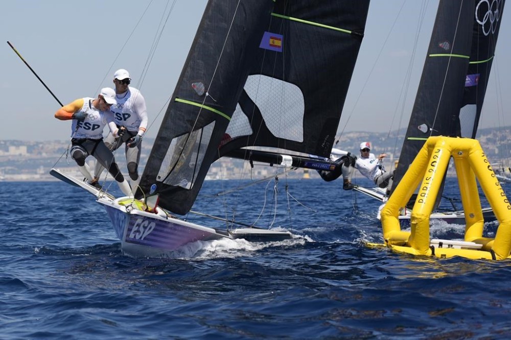 Florian Trittel Paul and Diego Botin Le Chever of Spain round a mark during a 49er skiff class practice race before the start of the 2024 Summer Olympics, Friday, July 26, 2024, in Marseille, France. (AP Photo/Carolyn Kaster)