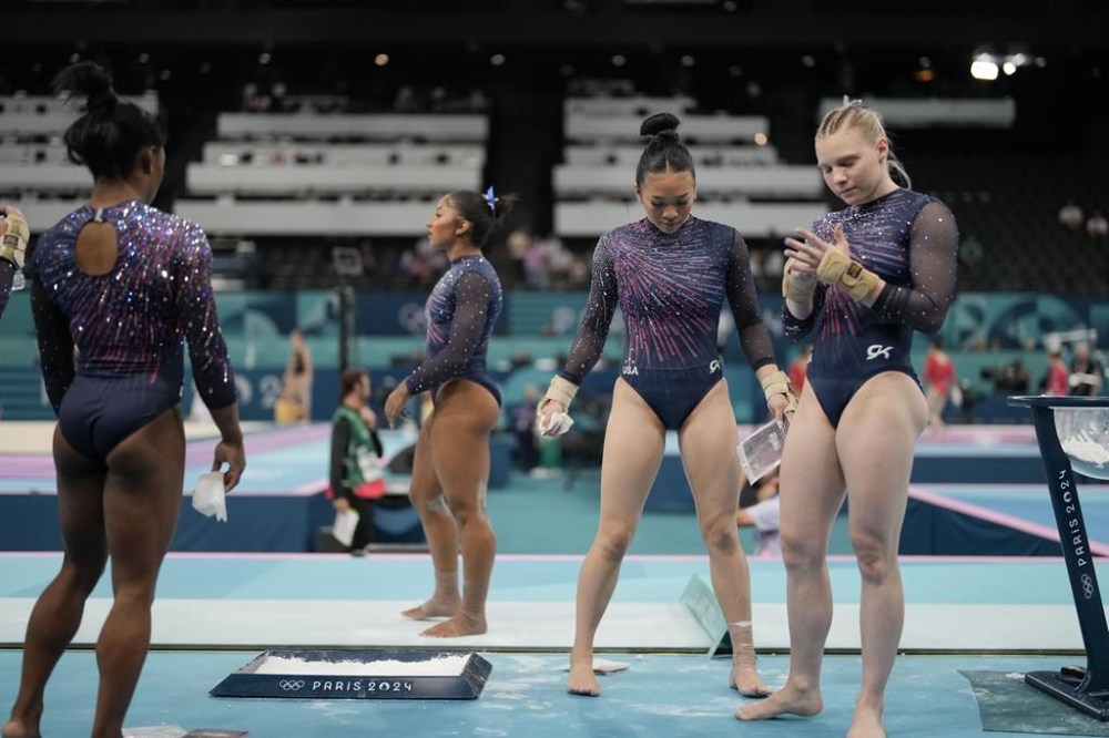 The United States team from left to right, Simone Biles, Jordan Chiles, Suni Lee and Jade Carey prepare to practice during a gymnastics training session at Bercy Arena at the 2024 Summer Olympics, Thursday, July 25, 2024, in Paris, France. (AP Photo/Francisco Seco)