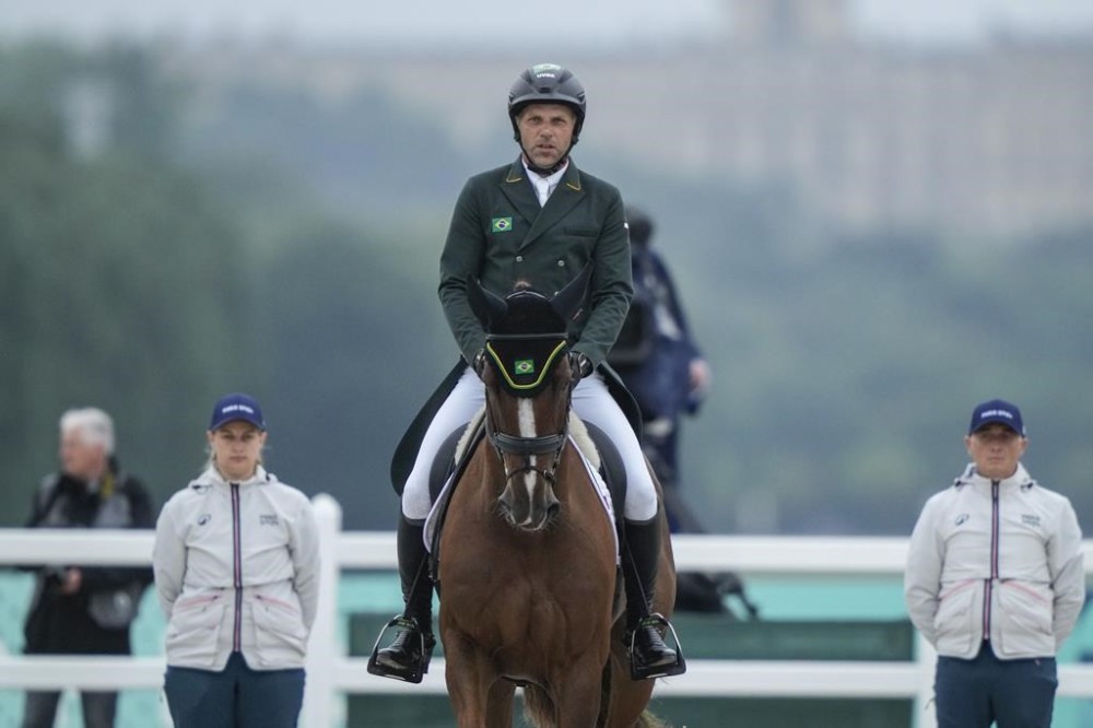 Brazil's Carlos Parros and his horse Safira during the Equestrian Eventing Dressage competition, at the 2024 Summer Olympics, Saturday, July 27, 2024, in Versailles, France. (AP Photo/Mosa'ab Elshamy)