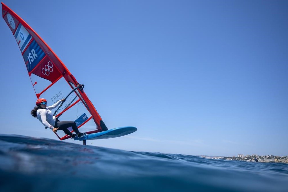 Sharon Kantor of Israel foils during the women's iQFOiL windsurfing class practice for the 2024 Summer Olympics, Saturday, July 27, 2024, in Marseille, France. The competition in sailing begins on Sunday. (AP Photo/Jacquelyn Martin)