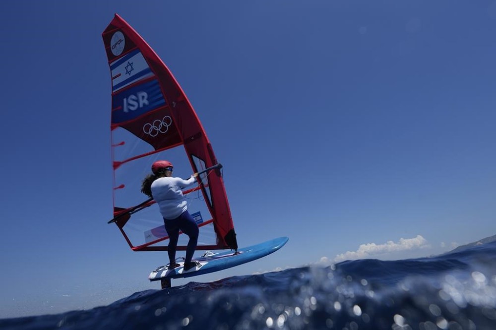 Sharon Kantor of Israel foils during a women's iQFOiL windsurfing class practice race at the 2024 Summer Olympics, Friday, July 26, 2024, in Marseille, France. (AP Photo/Carolyn Kaster)