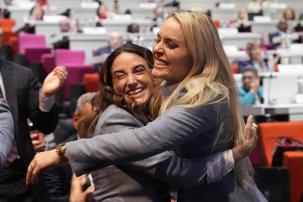 Former US skier Lindsey Vonn, right, hugs US Paralympic athlete Dani Aravich after Salt Lake City was named Olympics host again as the IOC formally awarded the 2034 Winter Games to the United States bid, at the 2024 Summer Olympics, Wednesday, July 24, 2024, in Paris, France. (AP Photo/David Goldman)