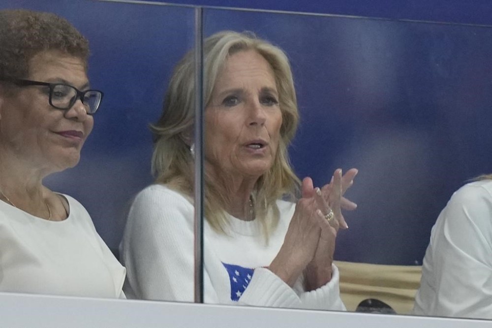 First lady Jill Biden watches a match during a women's Water Polo Group B preliminary match between USA and Greece at the 2024 Summer Olympics, Saturday, July 27, 2024, in Saint-Denis, France. (AP Photo/Luca Bruno)