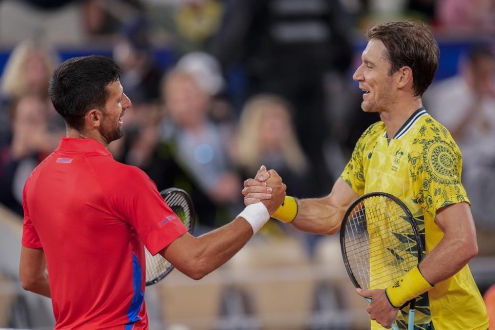 Serbian tennis player Novak Djokovic shakes hands with Matthew Ebden of Australia at the end of the men's singles tennis competition, at the 2024 Summer Olympics, Saturday, July 27, 2024, in Paris, France. (AP Photo/Manu Fernandez)