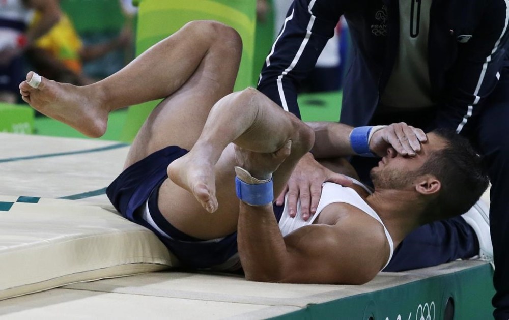 FILE - France's Samir Ait Said holds his leg after injuring it while performing on the vault during the artistic gymnastics men's qualification at the 2016 Summer Olympics in Rio de Janeiro, Brazil, Aug. 6, 2016. (AP Photo/Rebecca Blackwell, File)