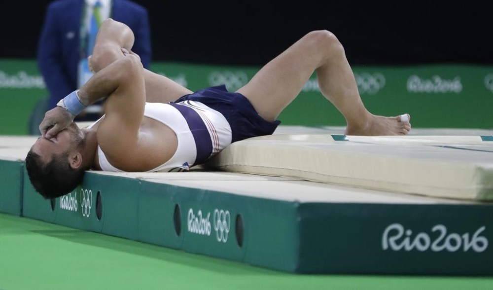 FILE - France's Samir Ait Said holds his leg after injuring it while performing on the vault during the artistic gymnastics men's qualification at the 2016 Summer Olympics in Rio de Janeiro, Brazil, Saturday, Aug. 6, 2016. (AP Photo/Julio Cortez, File)