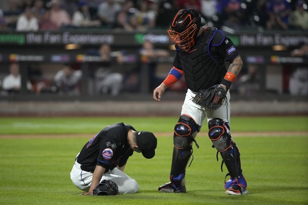 New York Mets' Francisco Alvarez checks on pitcher Kodai Senga after he sustained an injury during the sixth inning of a baseball game against the Atlanta Braves, Friday, July 26, 2024, in New York. (AP Photo/Pamela Smith)