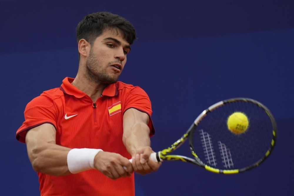 Carlos Alcaraz of Spain returns a backhand shot to Hady Habib of Lebanon during the men's singles tennis competition, at the 2024 Summer Olympics, Saturday, July 27, 2024, in Paris, France. (AP Photo/Andy Wong)