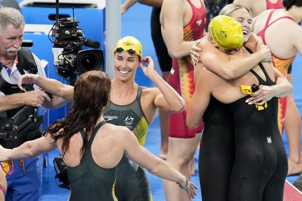 Emma Mckeon, Meg Harris, Shayna Jack and Mollie O'Callaghan of Australia, celebrate after winning the women's 4x100-meter freestyle final at the 2024 Summer Olympics, Saturday, July 27, 2024, in Nanterre, France. (AP Photo/Ashley Landis)