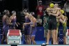 Swimmers from Australia, right, celebrate after winning the women's 4x100-meter freestyle relay final as the United States team, left, reacts at the 2024 Summer Olympics, Saturday, July 27, 2024, in Nanterre, France. (AP Photo/Matthias Schrader)