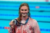 Summer McIntosh, of Canada, smiles as she holds her silver medal after the women's 400-metre freestyle final at the 2024 Summer Olympics, Saturday, July 27, 2024, in Nanterre, France. THE CANADIAN PRESS/Adrian Wyld