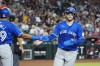 Toronto Blue Jays' Danny Jansen, right, celebrates his run against the Arizona Diamondbacks with Blue Jays' Leo Jimenez during the fourth inning of a baseball game Sunday, July 14, 2024, in Phoenix. THE CANADIAN PRESS/AP, Ross D. Franklin