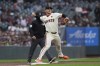 San Francisco Giants third baseman Matt Chapman turns a double play after forcing out Colorado Rockies' Kris Bryant at third to end the first game of a baseball doubleheader, Saturday, July 27, 2024, in San Francisco. Michael Toglia was out at first. (AP Photo/Godofredo A. Vásquez)