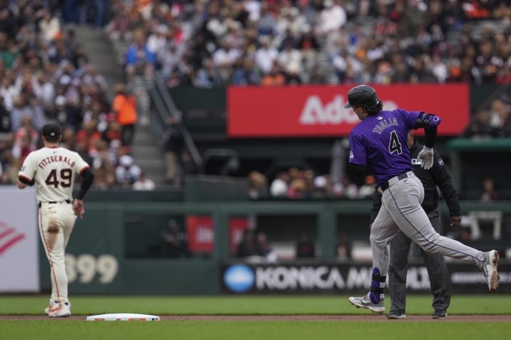 Colorado Rockies' Michael Toglia, right, runs the bases after hitting a solo home run against the San Francisco Giants during the seventh inning of the first game of a baseball doubleheader, Saturday, July 27, 2024, in San Francisco. (AP Photo/Godofredo A. Vásquez)