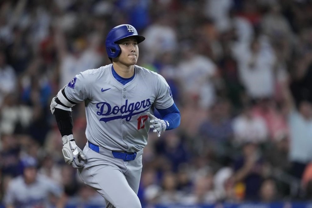 Los Angeles Dodgers designated hitter Shohei Ohtani runs the bases after hitting a solo home during the third inning of a baseball game against the Houston Astros, Saturday, July 27, 2024, in Houston. (AP Photo/Kevin M. Cox)