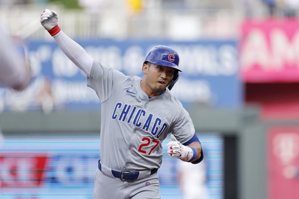 Chicago Cubs' Seiya Suzuki celebrates after his two-run home run as he runs the bases during the first inning of a baseball game against the Kansas City Royals in Kansas City, Mo., Saturday, July 27, 2024. (AP Photo/Colin E. Braley)