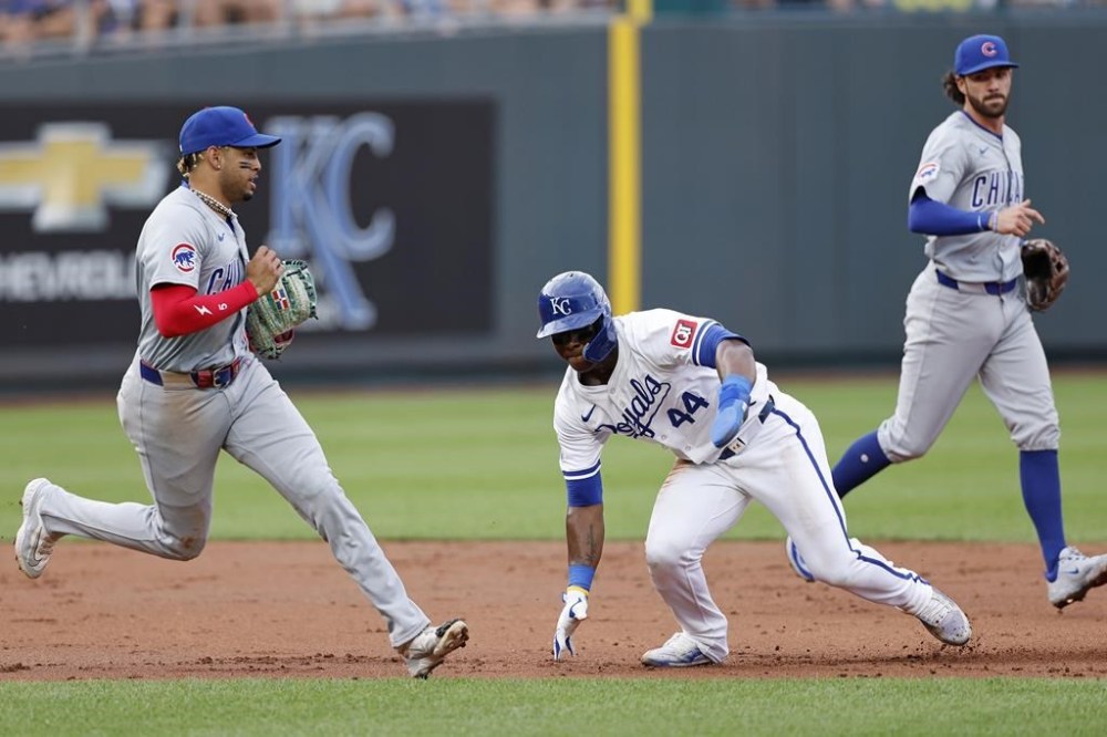Kansas City Royals' Dairon Blanco (44) gets caught in a rundown between second base and third base as Chicago Cubs Chicago Cubs third baseman Christopher Morel, left, and shortstop Dansby Swanson, right, run to the base line during the third inning of a baseball game in Kansas City, Mo., Saturday, July 27, 2024. Blanco was out on the play. (AP Photo/Colin E. Braley)