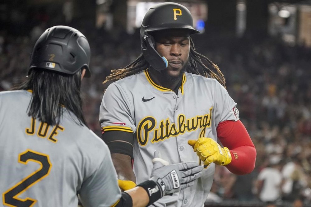 Pittsburgh Pirates' Connor Joe, left, greets Oneil Cruz after Cruz's solo home run against the Arizona Diamondbacks during the first inning of a baseball game, Saturday, July 27, 2024, in Phoenix. (AP Photo/Darryl Webb)