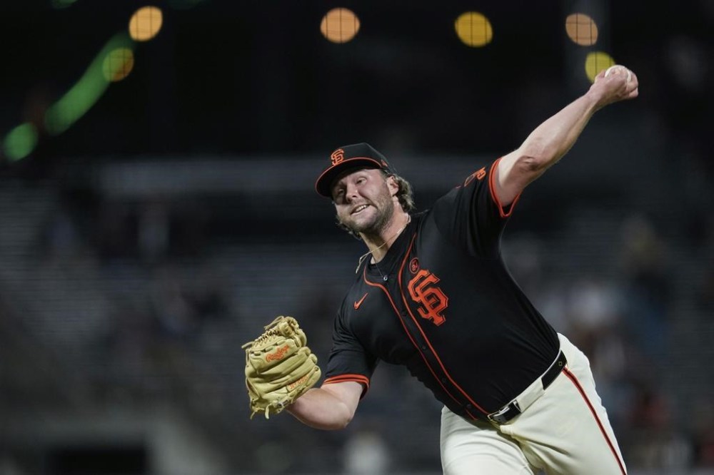 San Francisco Giants pitcher Erik Miller throws to a Colorado Rockies batter during the eighth inning of the second game of a baseball doubleheader Saturday, July 27, 2024, in San Francisco. (AP Photo/Godofredo A. Vásquez)